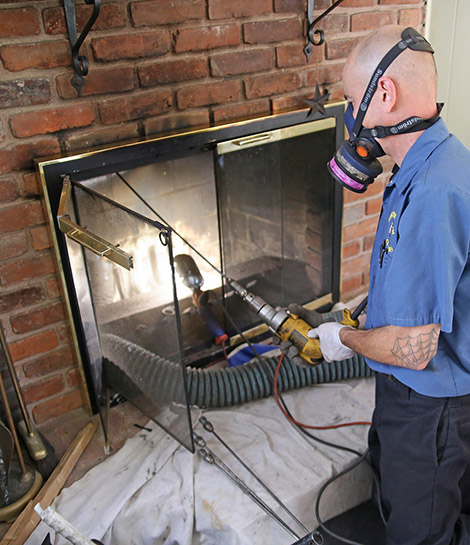 fireplace expert cleaning the chimney