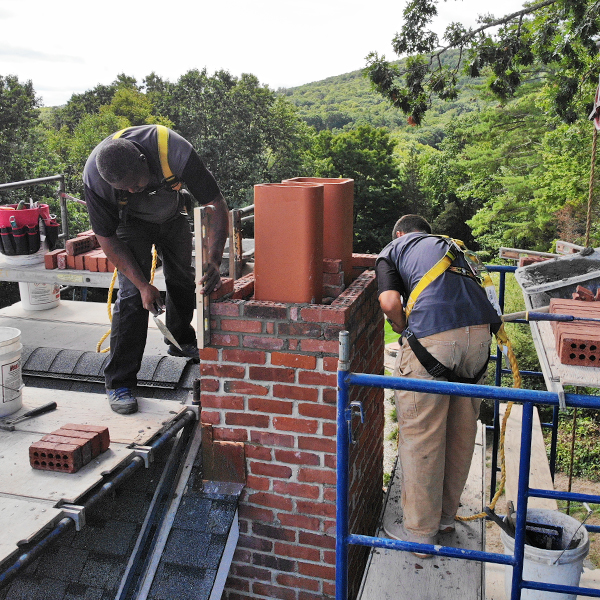 Chimney Sweep performing masonry chimney rebuilding on historic home Simsbury Rd Granby CT