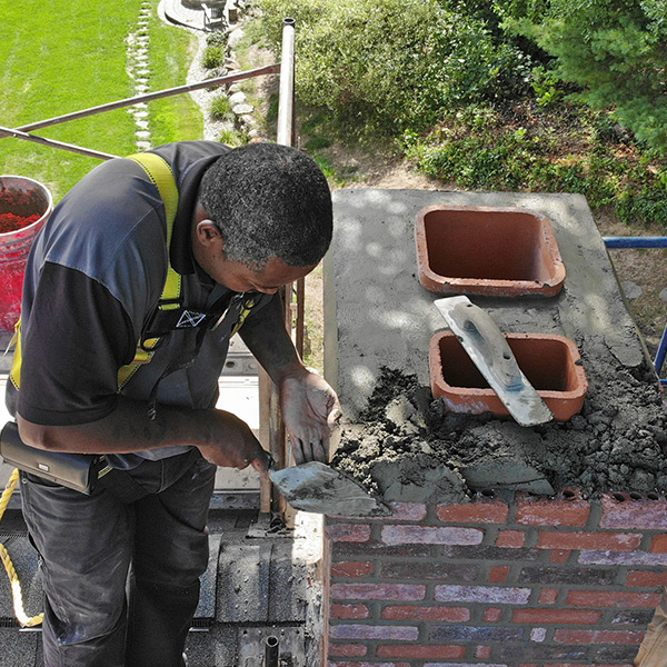 Chimney Sweep repairing a damaged chimney crown in Burlington CT